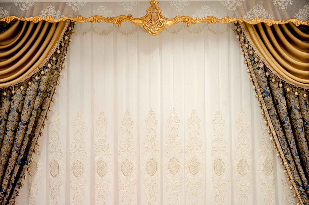 Elegant gold and blue drapes with intricate patterns create a luxurious setting.