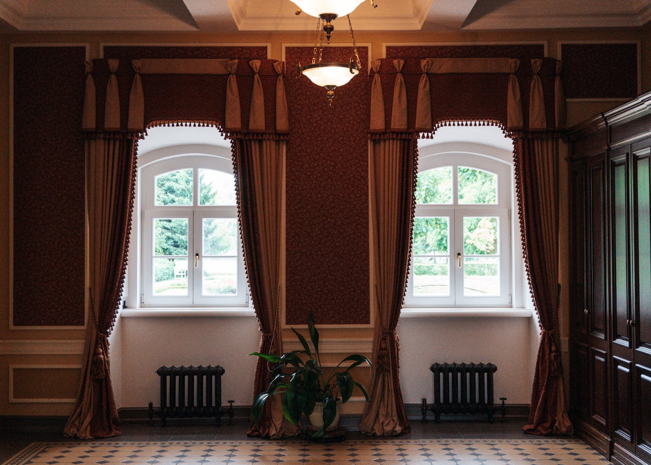 A luxurious interior showcasing vintage window drapes, elegant lighting, and classic decor elements.