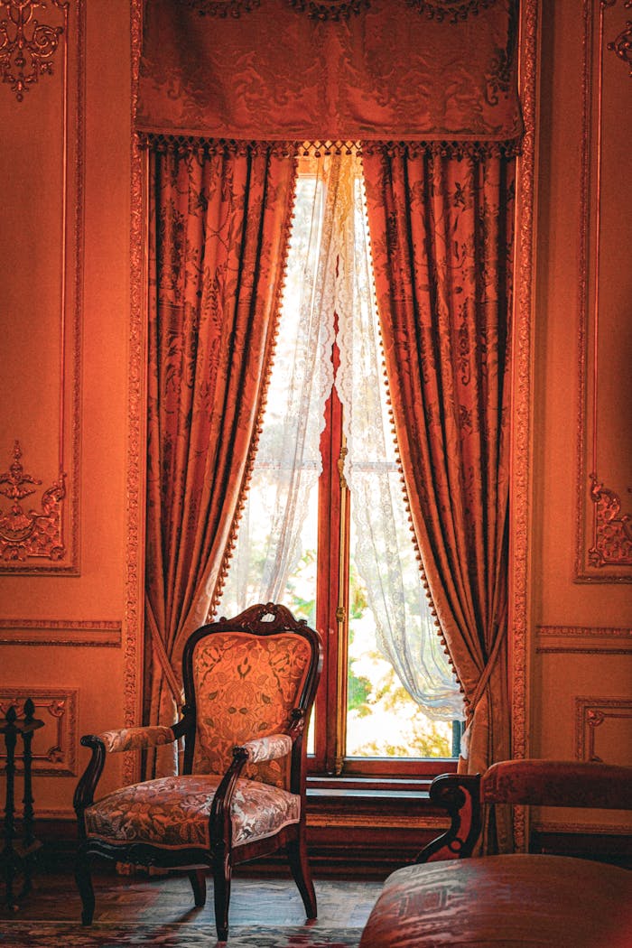 Vintage interior showcasing Ottoman-style decor with elegant drapes and antique furniture.